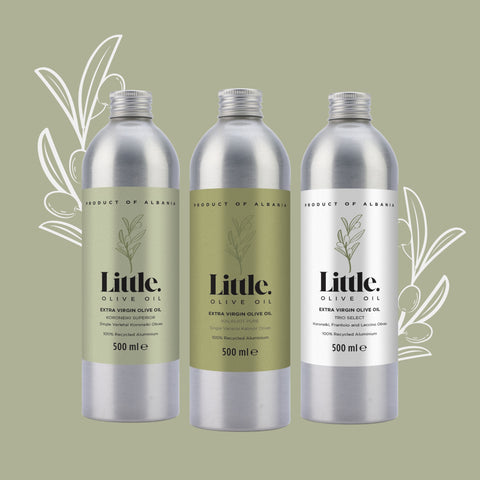 Three bottles of Little Olive Oil on a green background with olive branch illustrations.