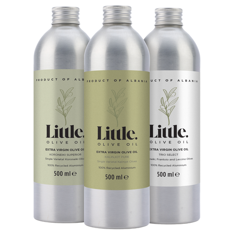 Three bottles of Little Olive Oil with silver caps and labels on a white background
